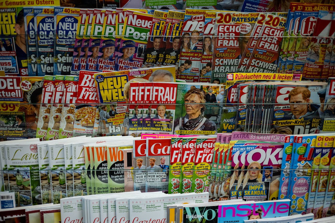 A vibrant display of magazines in a newsstand, showcasing various colorful covers and headlines.